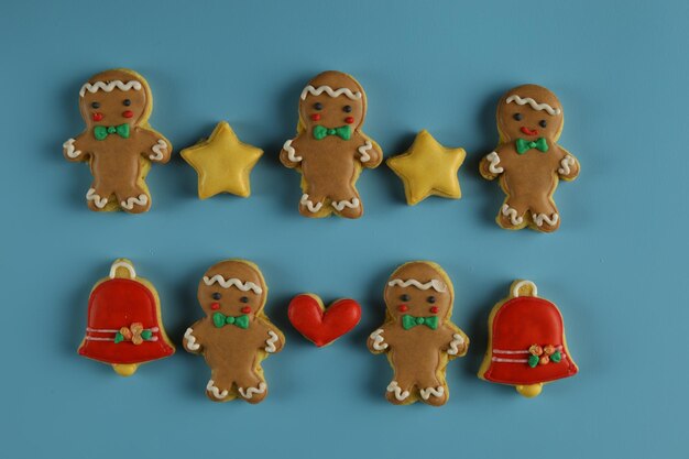Christmas cookies with star, belts and ginger man shape in blue background. Isolated
