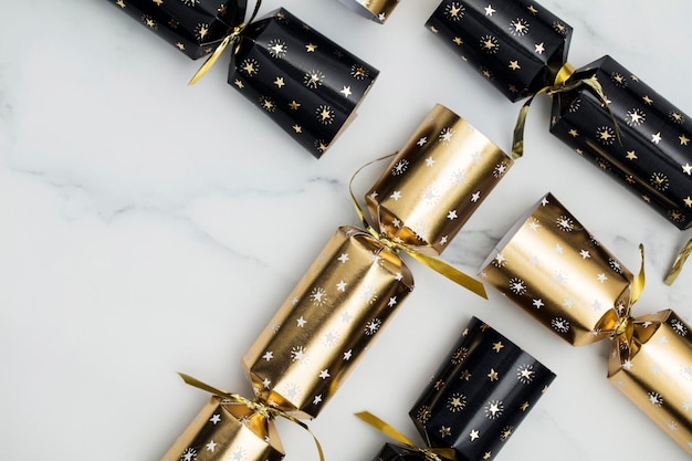 Christmas crackers luxury gold and black festive crackers on a marble background