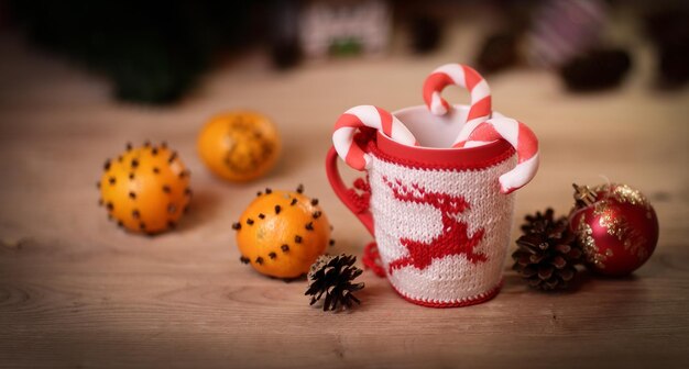 Christmas Cup and oranges on wooden background blurred