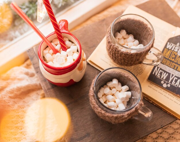 Christmas cup with marshmallows on a wooden stand