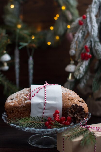 A Christmas cupcake on the background of a Christmas tree with lights Serving flour products