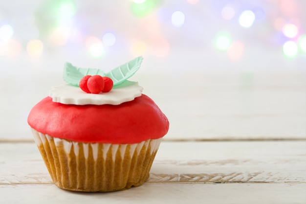 Christmas cupcake on white wooden table Copyspace