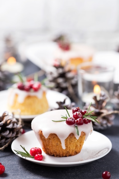 Christmas cupcake with sugar icing, cranberries and rosemary