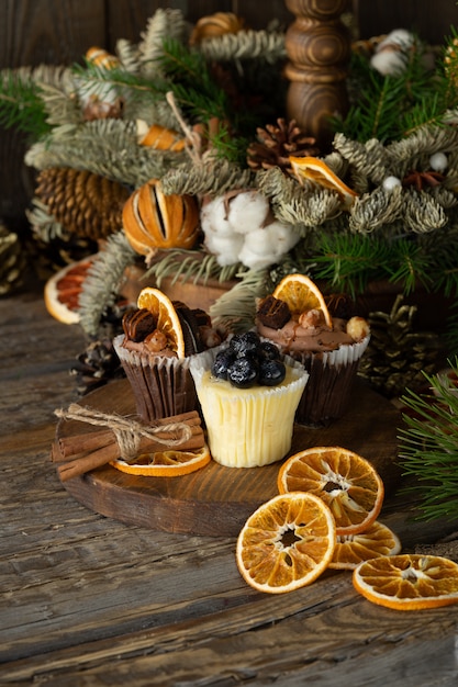 ベリーで飾られたホワイトとダークチョコレートで作られたクリスマスカップケーキ