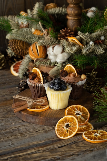 Christmas cupcakes made of white and dark chocolate, decorated with berries