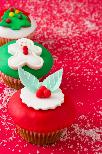 Christmas cupcakes on red background