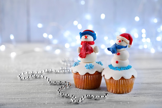 Christmas cupcakes with lights on surface