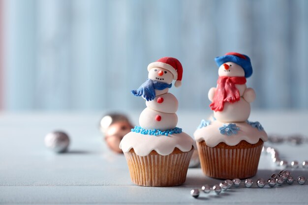 Christmas cupcakes with lights on surface