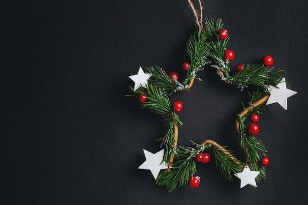 Christmas deco star wreath on black. Flat Lay.