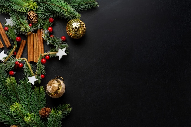 Christmas deco with fir and baubles on dark background. Flat Lay. Christmas concept