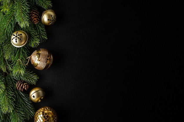 Christmas deco with fir and baubles on dark.