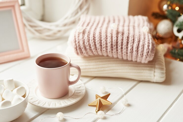 Christmas decor, balls, woolen plaid on the window , home comfort concept, seasonal winter celebrations. . Christmas pink cup with marshmallow.