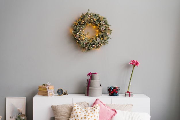 Christmas decor in the house and a wreath on the wall in the interior