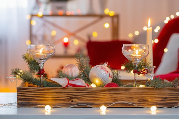 Christmas decor in red color with burning candles at home