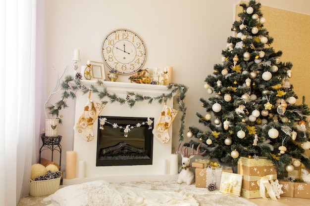 Christmas decorated house interior with fireplace, wall clock, xmas tree and presents under it. Merry xmas and new year concept.