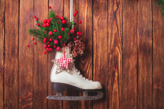 Christmas decorated skate on the wooden wall