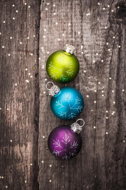 Christmas decoration ball on textured grungy wooden surface