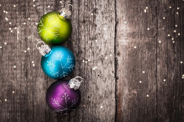 Christmas decoration ball on textured grungy wooden surface