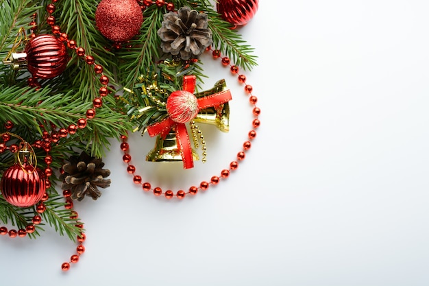 Christmas decoration bell, pine cones and branch