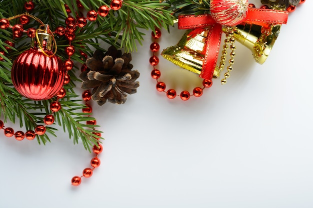 Christmas decoration bell, pine cones and branch