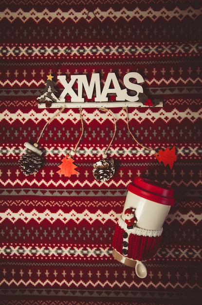 Photo christmas decoration and bottle with santa spoon on red and white pattern