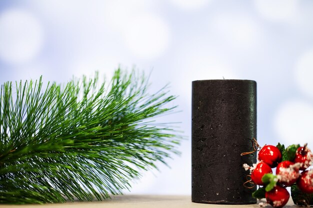 Christmas decoration and candle on blue background