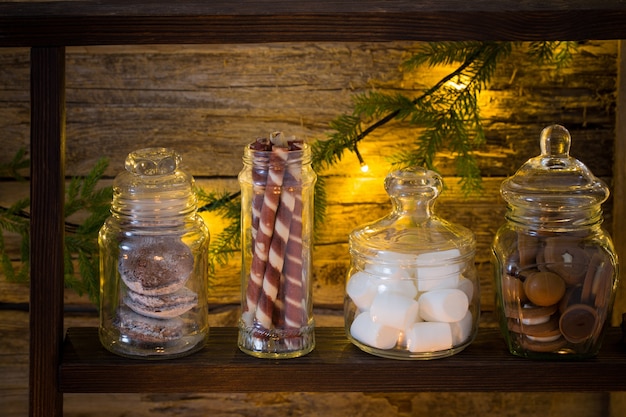 Christmas decoration cocoa bar with cookies and sweets on old wooden background