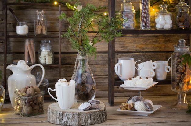 Christmas decoration cocoa bar with cookies and sweets on old wooden background