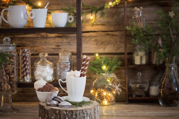 Christmas decoration cocoa bar with cookies and sweets on old wooden background