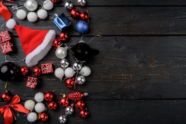 Christmas decoration collection set, top view flat lay, on black wooden table background, with copy space for text