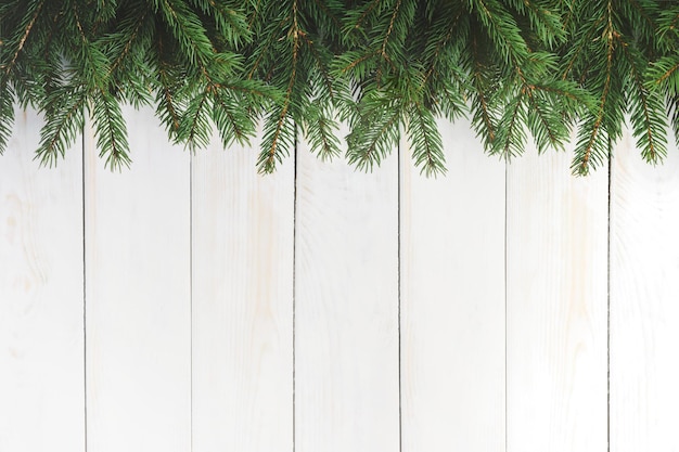 Christmas decoration concept spruce branches on an old white wooden vintage table with copy space