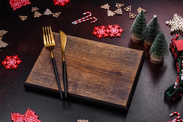 Christmas decoration elements as well as gingerbread on a brown concrete background