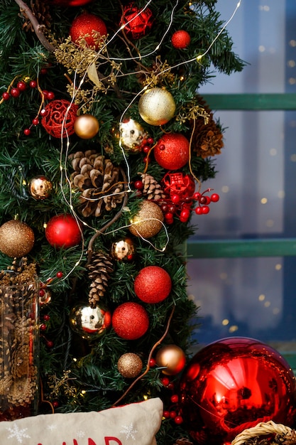 Christmas decoration from fir branches and toys on the window in a cozy home. Christmas toys in the room