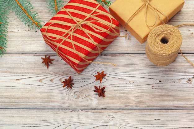 Christmas decoration, gift box and pine tree branches on wooden background