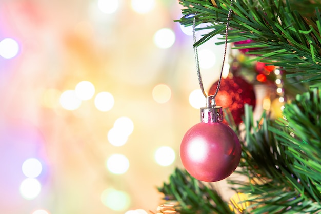 Christmas decoration. Hanging pink balls on pine branches Christmas tree garland and ornaments