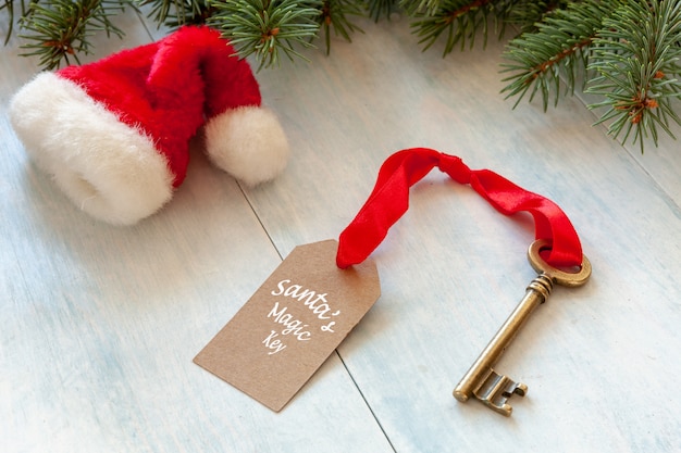 Christmas decoration - Santa's Magic Key and SantaÃ¢ÂÂs hat. Close-up on light blue back