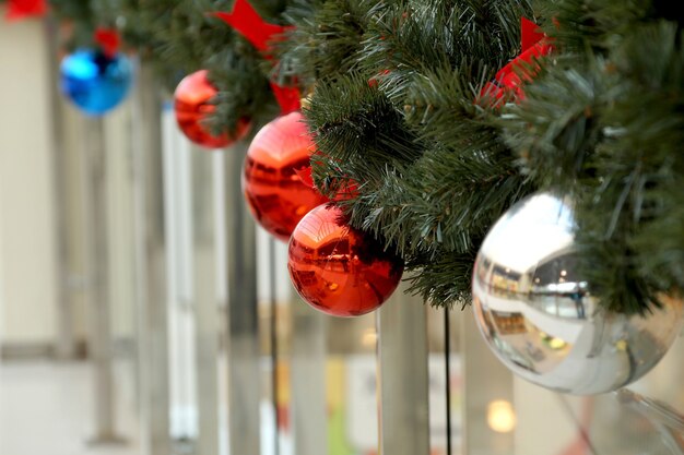 Christmas decoration of shopping center spheres, bows and branches of a fir-tree