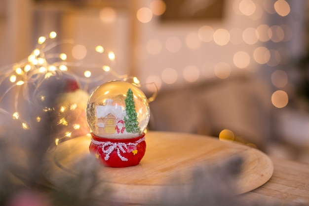 Christmas decoration, snow dome, globe with table decoration, Santaclaus on sleigh with child in winter 