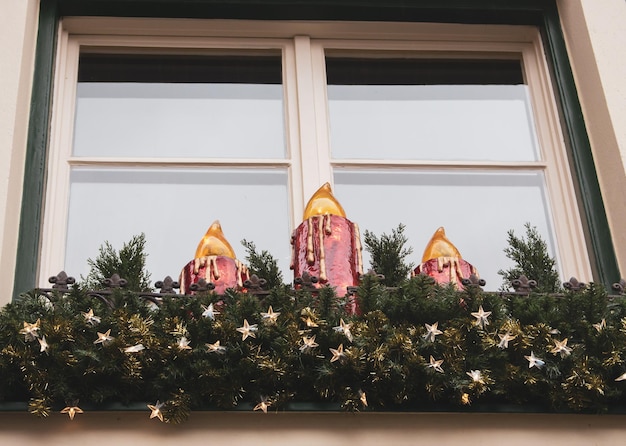 Christmas decoration on street in Europe. New year atmosphere in city. Christmas tree, candles, star