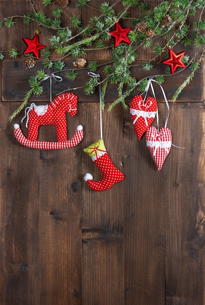 Christmas decoration textile handmade toys over rustic wooden background. nostalgic picture with retro style design