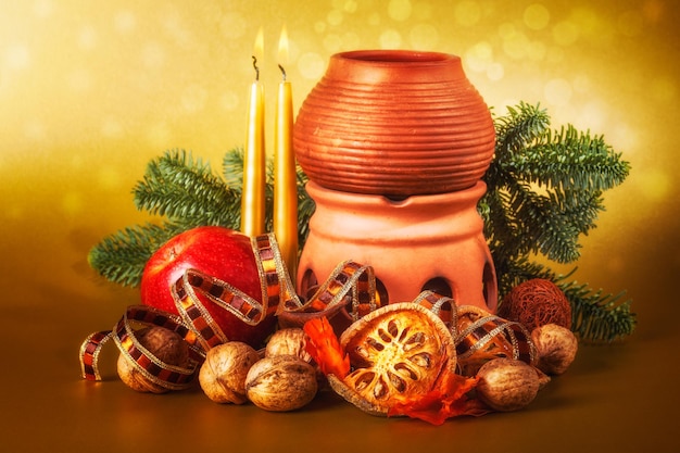 Christmas decoration with aroma lamp and candle for advent season on gold background