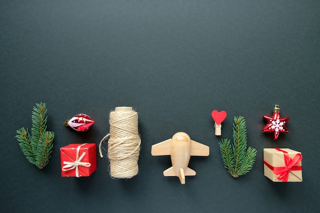 Christmas decoration with branches, stars and gift boxes on black background