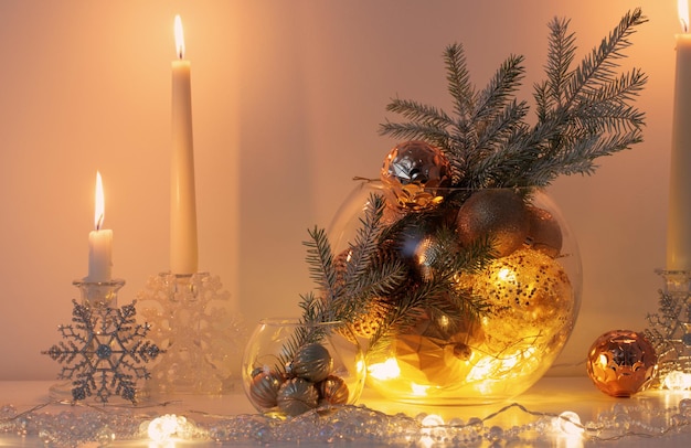 Christmas decoration with burning candles in white interior