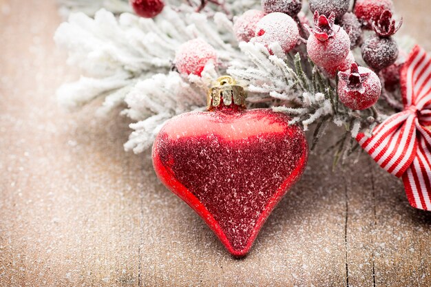 Christmas decoration with fir branches on the wood background.