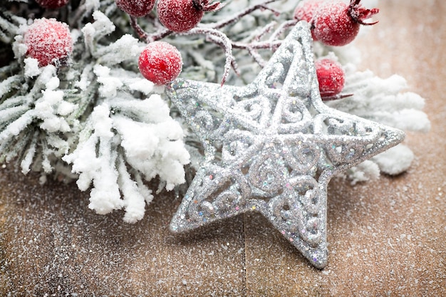 Christmas decoration with fir branches on the wood background.