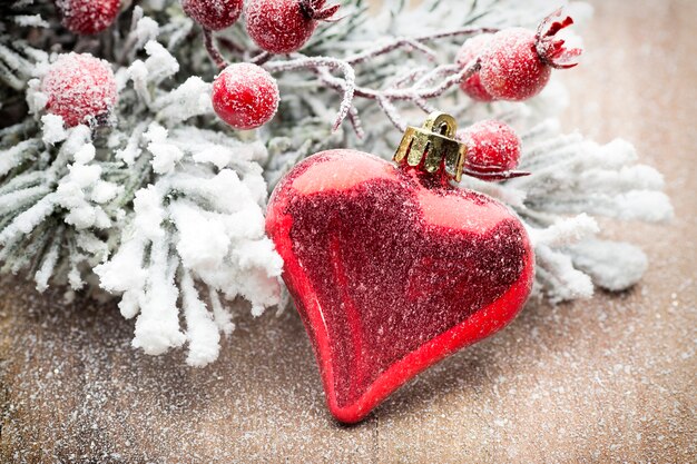 Christmas decoration with fir branches on the wood background.