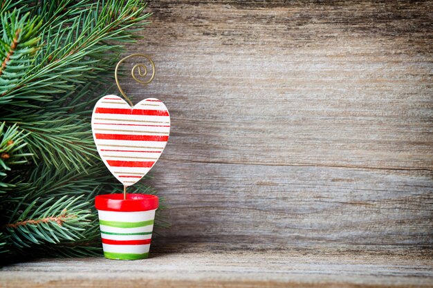 Christmas decoration with fir branches on the wood background