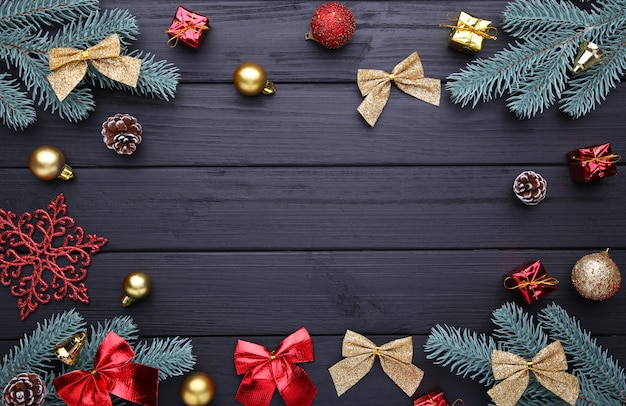 Christmas decoration with Fir-tree branch and balls on a wooden background