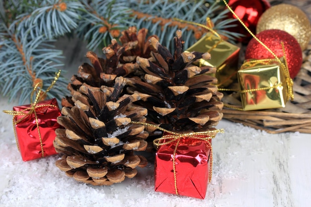 Christmas decoration with pine cones on wooden background