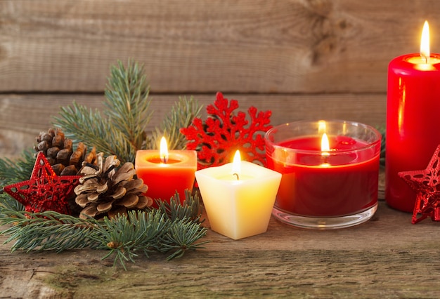 Christmas decoration with red candles on wooden table